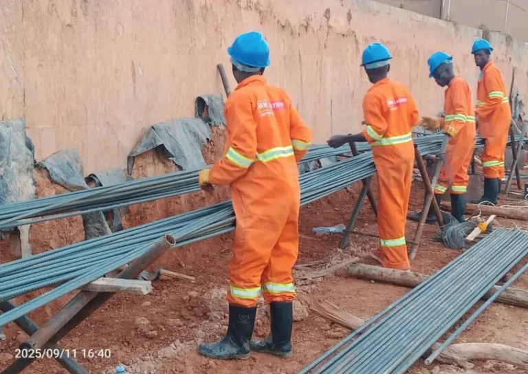 Workers handling reinforcement bars on site