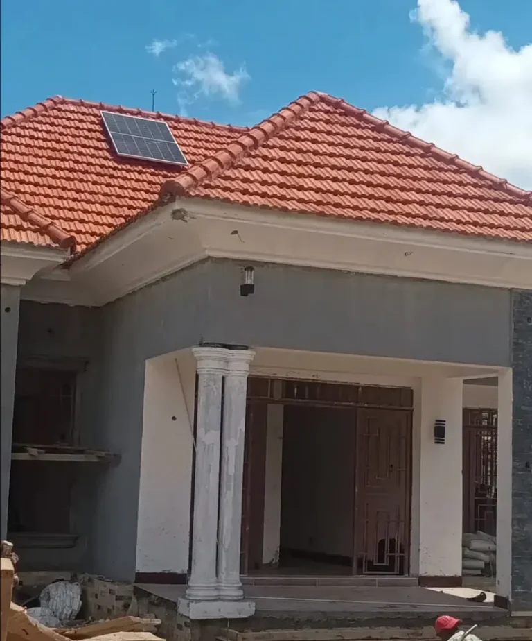 House with a clay-tiled roof and solar panel, finished exterior and entrance columns