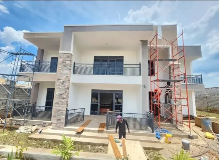 Two-storey house with scaffolding during exterior finishing