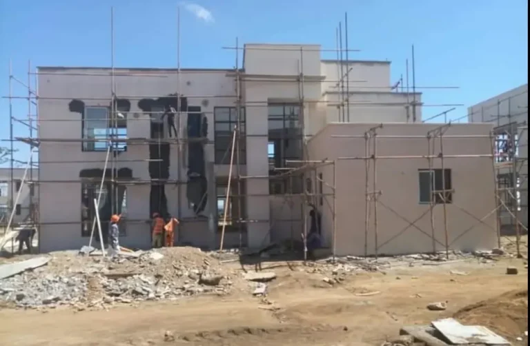 House at the plastering stage with scaffolding