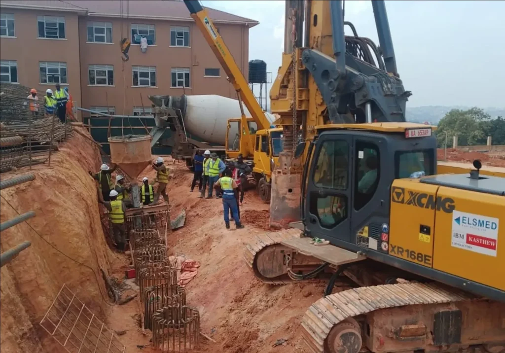 Piling rig and crew working in a deep foundation excavation