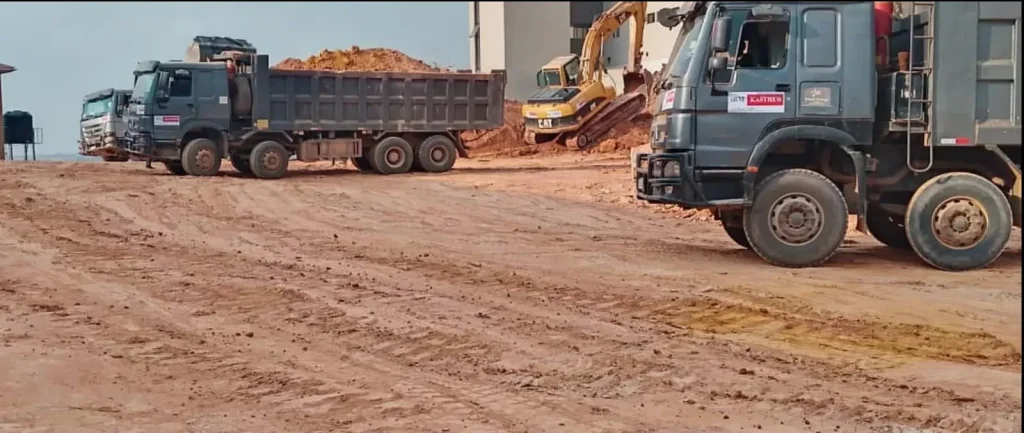 Dump trucks moving soil on an earthworks site