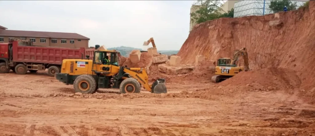 Wheel loader and excavators loading dump trucks on an earthworks site