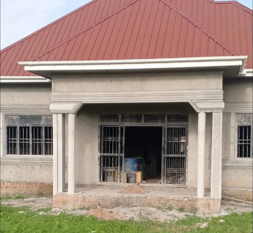 Entrance veranda of a bungalow with white columns and a grilled doorway