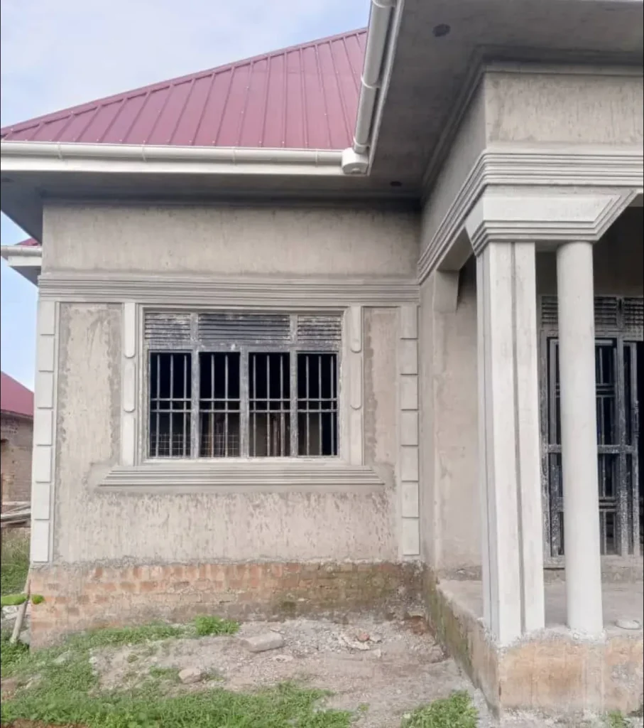 Side elevation of a bungalow showing a barred window and entrance columns