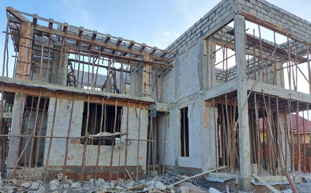 Two-storey block structure with timber props under the formwork