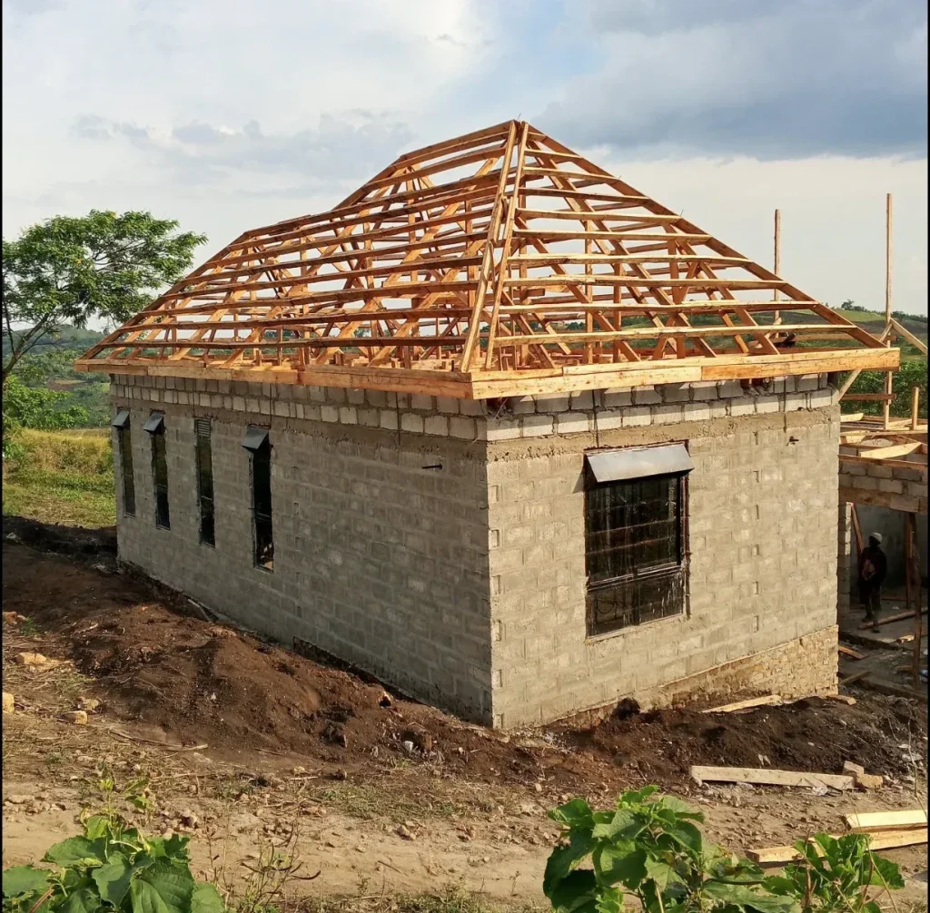 Block house on sloping ground with a timber hip roof frame